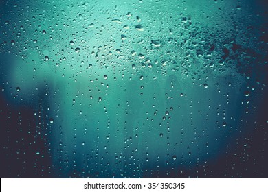 vintage color tone of Water and rain drops on the glass, abstract view, Drops of rain on blue glass background / drops on glass after rain. Image has shallow depth of field.  - Shutterstock ID 354350345