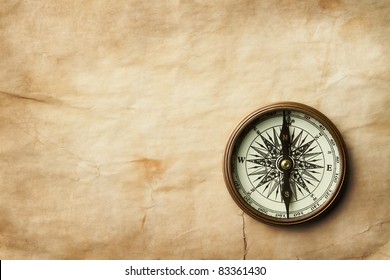 Vintage compass at old crumpled paper with copy space - Shutterstock ID 83361430
