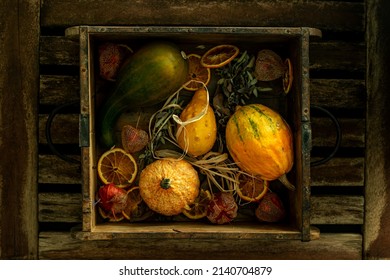 Vintage composition with pumpkins and dry fruits in wooden box - Shutterstock ID 2140704879