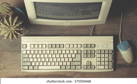 Vintage computer on a wooden table. Top view
