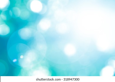 Vintage Cool Cyan Blue Green Color Blurred Sky Background With Nature Glowing Sun Light Flare And Bokeh