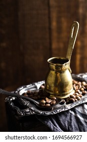 Vintage Copper Stovetop Coffee Pot Shot On A Dark Textured Wooden Background Backlit Surrounded By Coffee Beans 