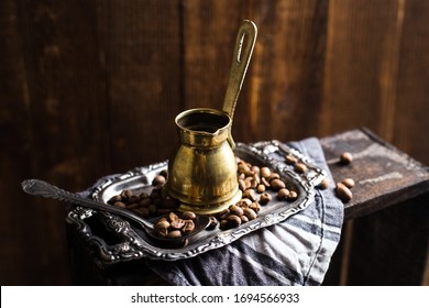 Vintage Copper Stovetop Coffee Pot Shot On A Dark Textured Wooden Background Backlit Surrounded By Coffee Beans 