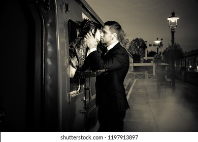 Vintage Couple, Handsome Man In Uniform, Kissing Goodbye His Lover On Railway Station Platform As Train Is About To Leave.