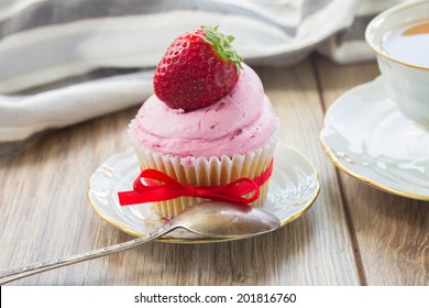 vintage  cupcake with fresh strawberry in plate on wooden table
