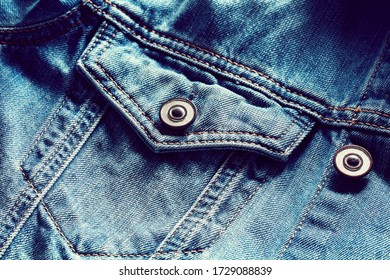 Vintage Denim Or Blue Jeans Jacket Pocket And Button. Close Up View. 