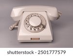 Vintage dial telephone. Isolated white telephone. Analog communication system. Old fashioned telephone 50s