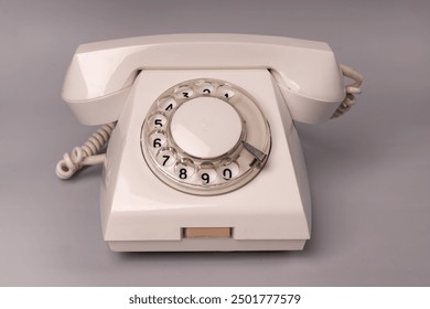 Vintage dial telephone. Isolated white telephone. Analog communication system. Old fashioned telephone 50s - Powered by Shutterstock