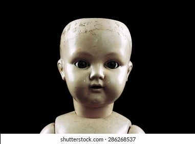 Vintage doll face isolated on black with clipping path 
