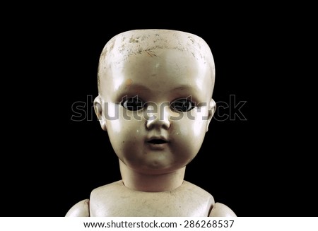 Vintage doll face isolated on black with clipping path 