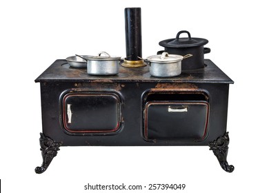 Vintage doll house cooking stove with pans isolated on a white background