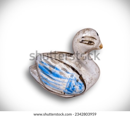A vintage duck sculpture, made from limestone and artfully isolated on white. Focus on intricate details. Quirky decor element.