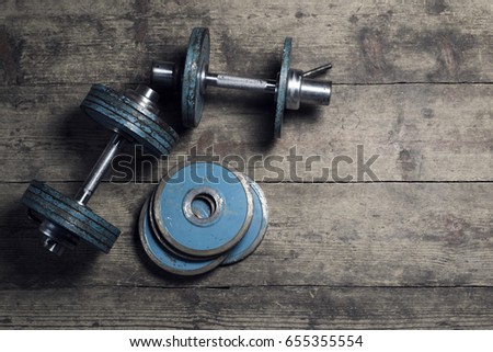 Vintage dumbbells on the wooden floor. Top view . Flat lay. Old school. Vintage.  With lighting effects.