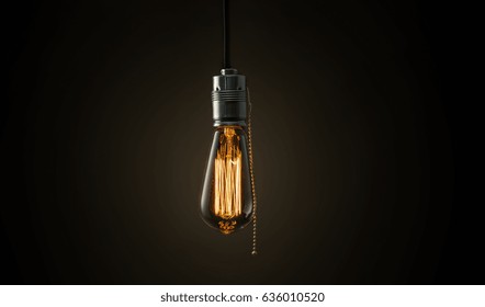 Vintage Edison lightbulb on dark background with bright yellow shining wire