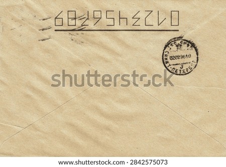 A vintage envelope with a unique code and a round postmark. The postmark contains Cyrillic text, highlighting the origin as St. Petersburg.