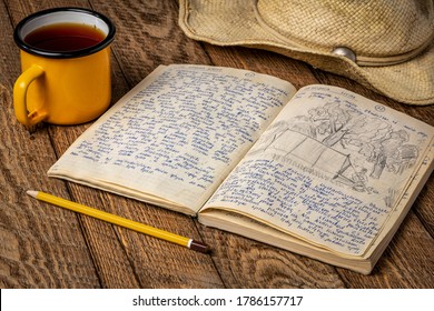 Vintage Expedition Journal On A Rustic Picnic Table With A Cup Of Tea And Straw Hat - Handwriting And Drawing In Travel Log From 1974 Paddling Trip In Poland (property Realease Attached).