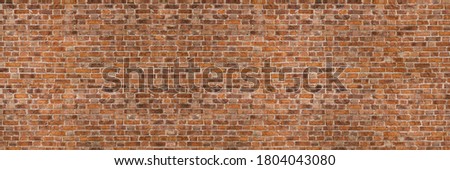 Vintage exposed brown and red old brick wall. Brickwork textured background and long brown banner.