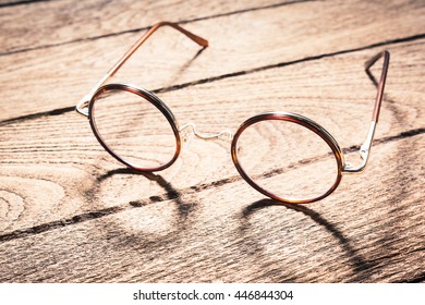 Vintage Eyeglasses On Old Wooden Table