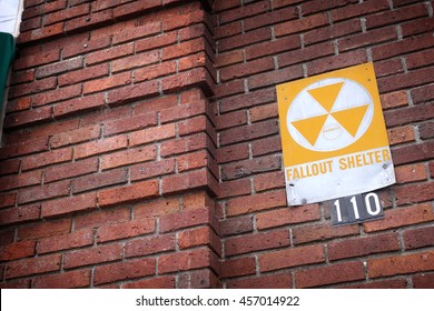 vintage fallout shelter sign on old brick building                              