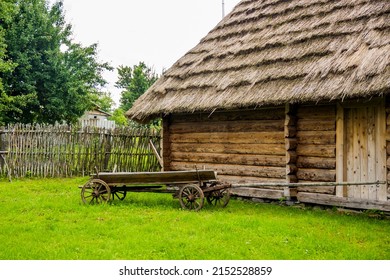 vintage farmyard with cart carriage near the wooden barn and wicker fence in reconstruction of ukrainian village of 19th century as part of Ivan Franko Literary Memorial Museum in Nahuievychi, Ukraine
