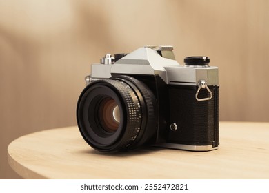 A vintage film camera with a 50mm lens, known for its beautiful bokeh, adds a touch of classic charm for photography enthusiasts. - Powered by Shutterstock