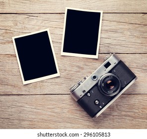 Vintage Film Camera And Two Blank Photo Frames On Wooden Table. Top View