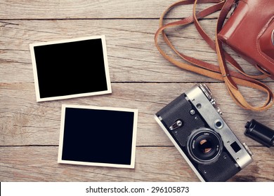 Vintage Film Camera And Two Blank Photo Frames On Wooden Table. Top View