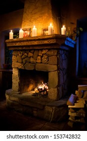 Vintage Fireplace Room Interior. Chimney Place, Candles Fire Woodpile. Romantic Still Life Scene