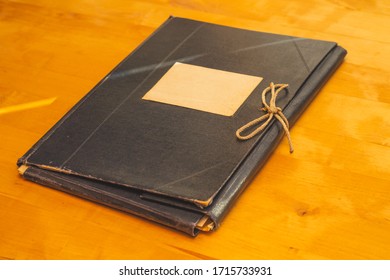 Vintage Folder For Paper With Blank Label. Old Folder For Documents Lies On A Wooden Table. Copy Space