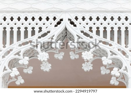 Vintage forged iron arch, white ornamental decoration, close-up photo