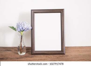 Vintage frame photo with violet flower on table