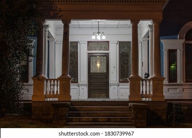 Vintage front porch on victorian house in antebellum south at night