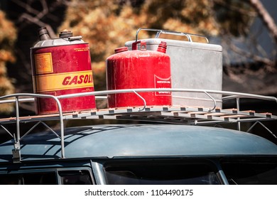 Vintage Gas Cans And Ice Chest On Top Of An Car