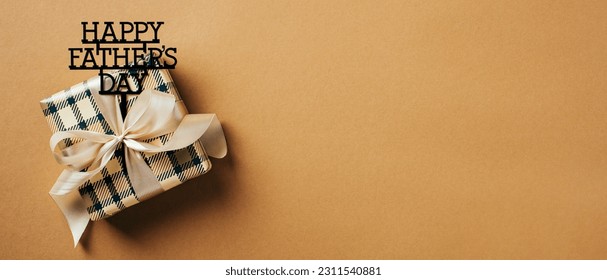 Vintage gift box with ribbon bow on brown background with copy space. Vintage style. Happy Fathers Day concept. - Shutterstock ID 2311540881