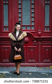 Vintage girl with the old doors on the background