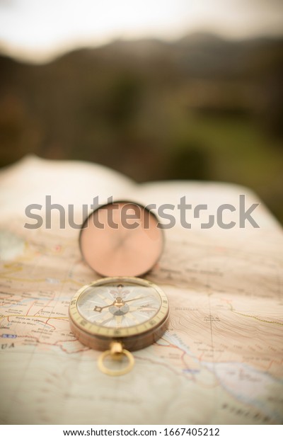 Vintage golden compass over
map