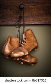 Vintage Golden Football Boots Hanging On A Locker Room