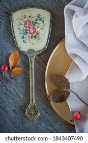 Vintage Golden Hand Mirror And Golden Tay With Red Apples On A Wooden Background