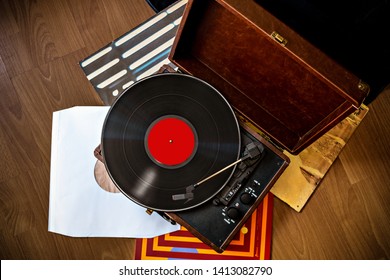 Vintage gramophone in case with vinyl plaing and vinyl covers top view