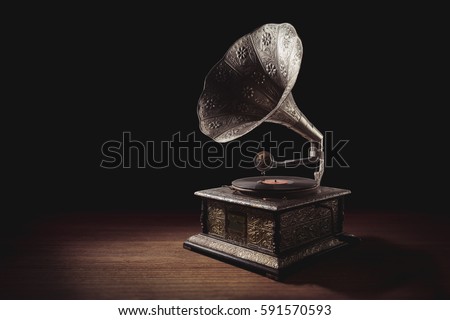 vintage gramophone on a wooden background with dramatic lighting