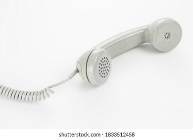 Vintage Gray Telephone Receiver With Chord, In Bright Studio Setting.