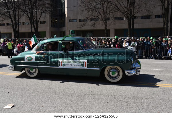 vintage\
green car in for O\'Brien\'s Restaurant in the Chicago Saint\
Patrick\'s Day Parade, Chicago, IL March 17,\
2018