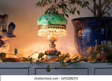 A Vintage Green Lamp Surrounded By House Plants In A City Loft Interior In Strijp S, Eindhoven, The Netherlands. A Mix And Mach, Eclectic Styled Home With Bohemian Influences. Detail Shot 