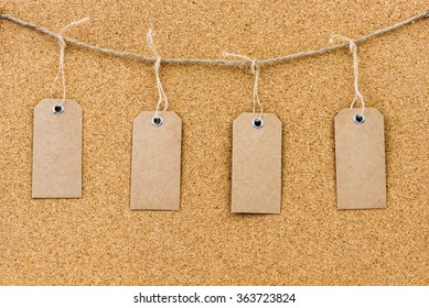 Vintage Grunge Empty Tags Hanging On Rope String Over Cork Board Texture Background, Available Copy Space