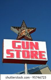 Vintage Gun Store Sign With Blue Sky