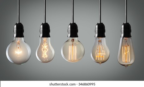 Vintage hanging light bulbs over gray background 