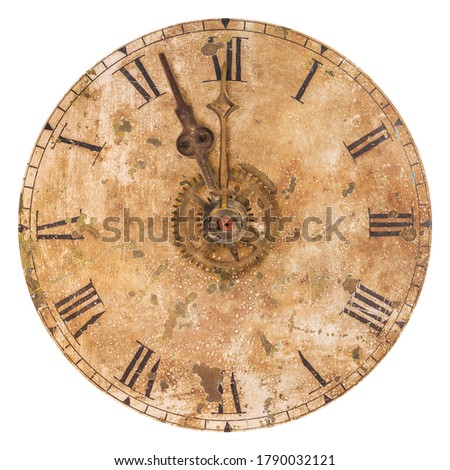 Vintage and heavily weathered clock face with time set to a few minutes to twelve o clock isolated on a white background