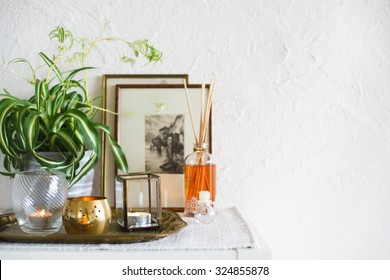 Vintage Home Decor: Candles, Aroma Diffuser, Plant And Frames. Selective Focus