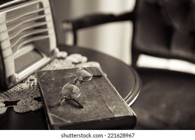 Vintage Home Interior With Old Radio And Book On Round Wooden Table.