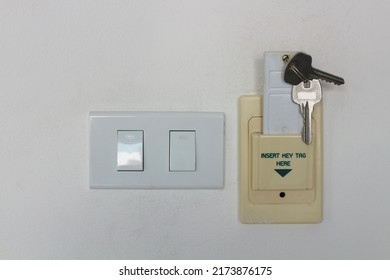 Vintage Hotel Keycard Holder And Light Switch, Turn On And Turn Off, On White Wall Background.